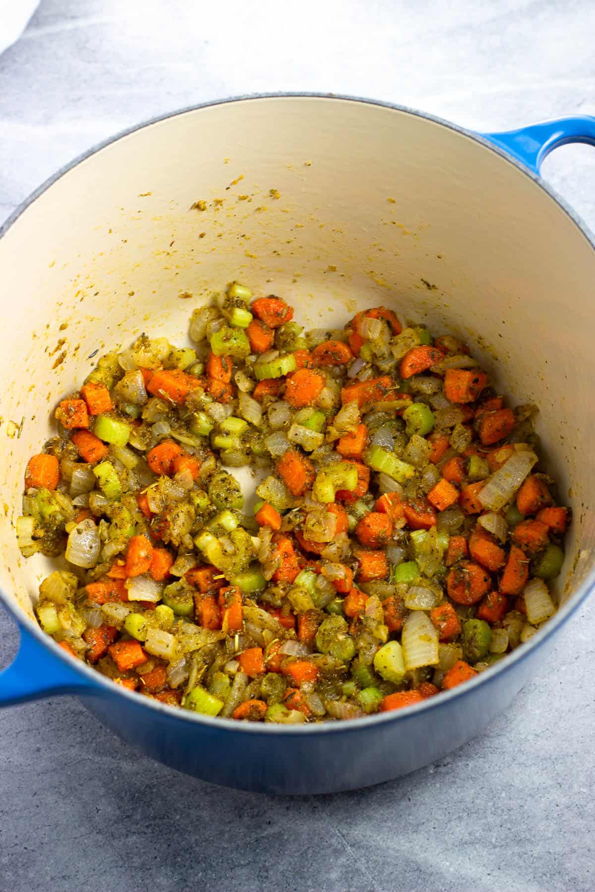 Flour and dried seasonings added to the pot with the sautéed vegetables.