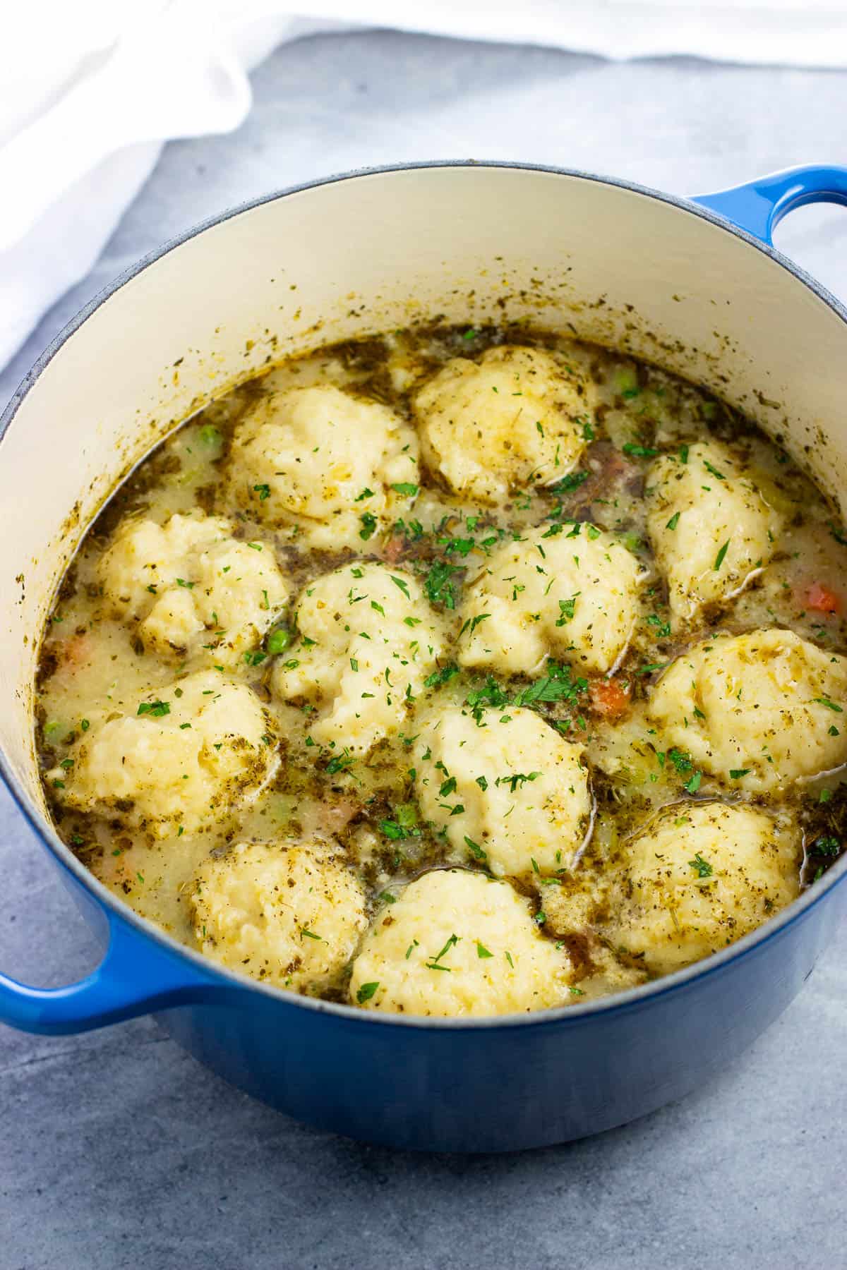 Cooked chicken and dumplings in a Dutch oven.