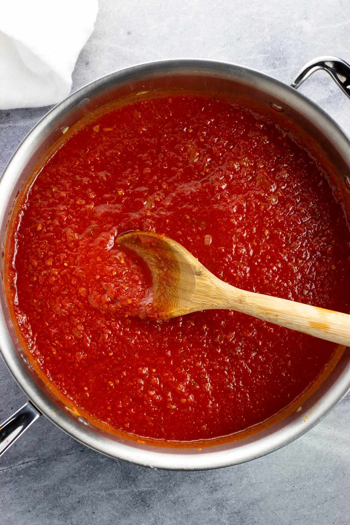 Crushed tomatoes poured into the pan.