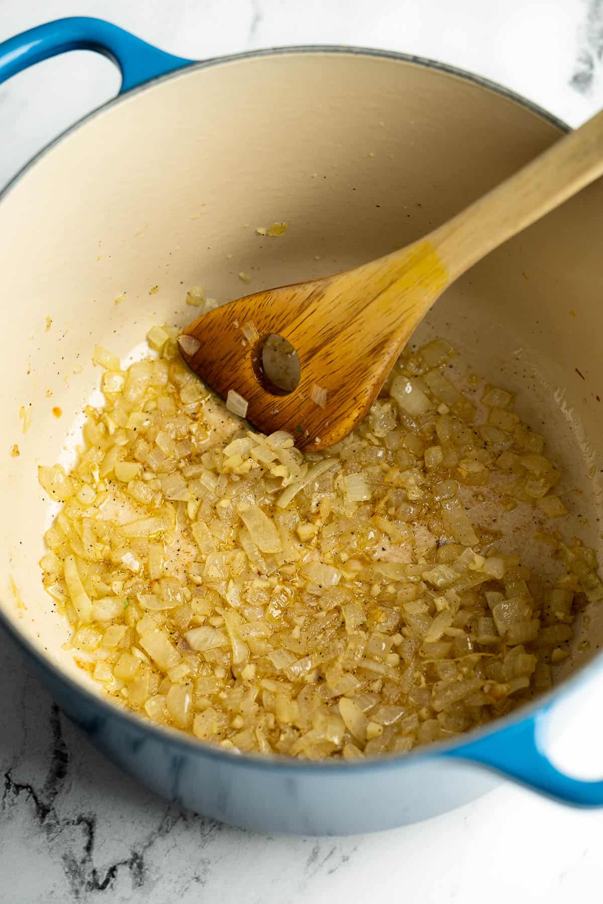 Sautéed onion and garlic in a pot.