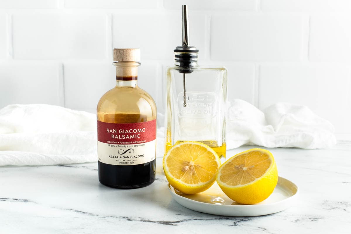 Soup accompaniments on a counter: good balsamic, olive oil, and lemon.