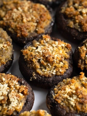 A serving plate of Italian stuffed mushrooms.