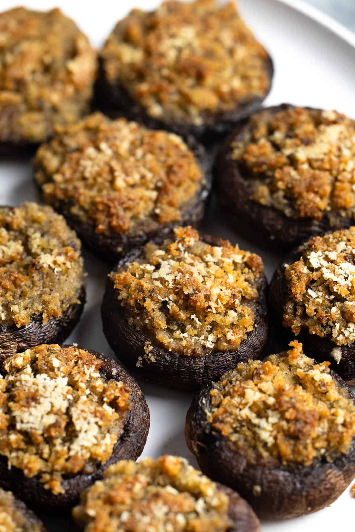 A serving plate of Italian stuffed mushrooms.