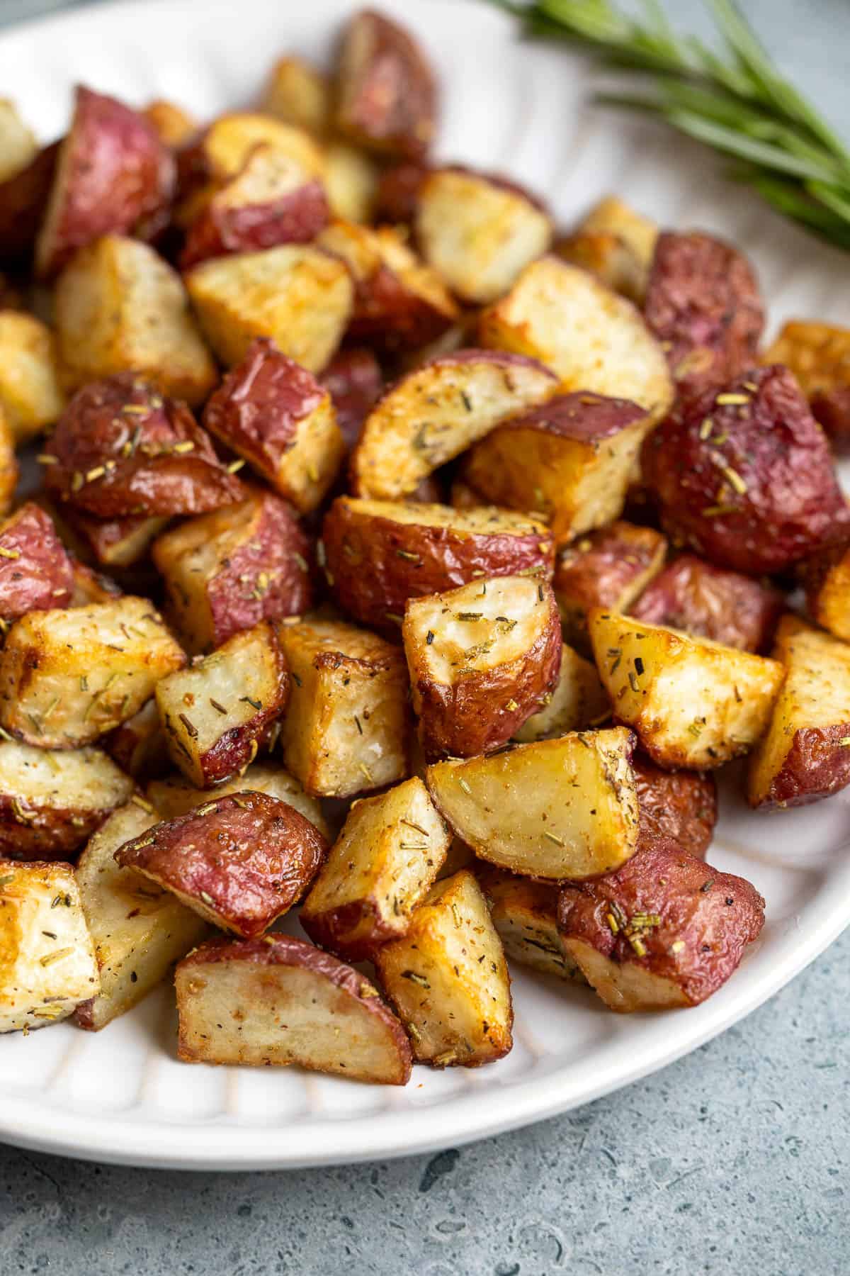 Roasted garlic rosemary potatoes on a plate.