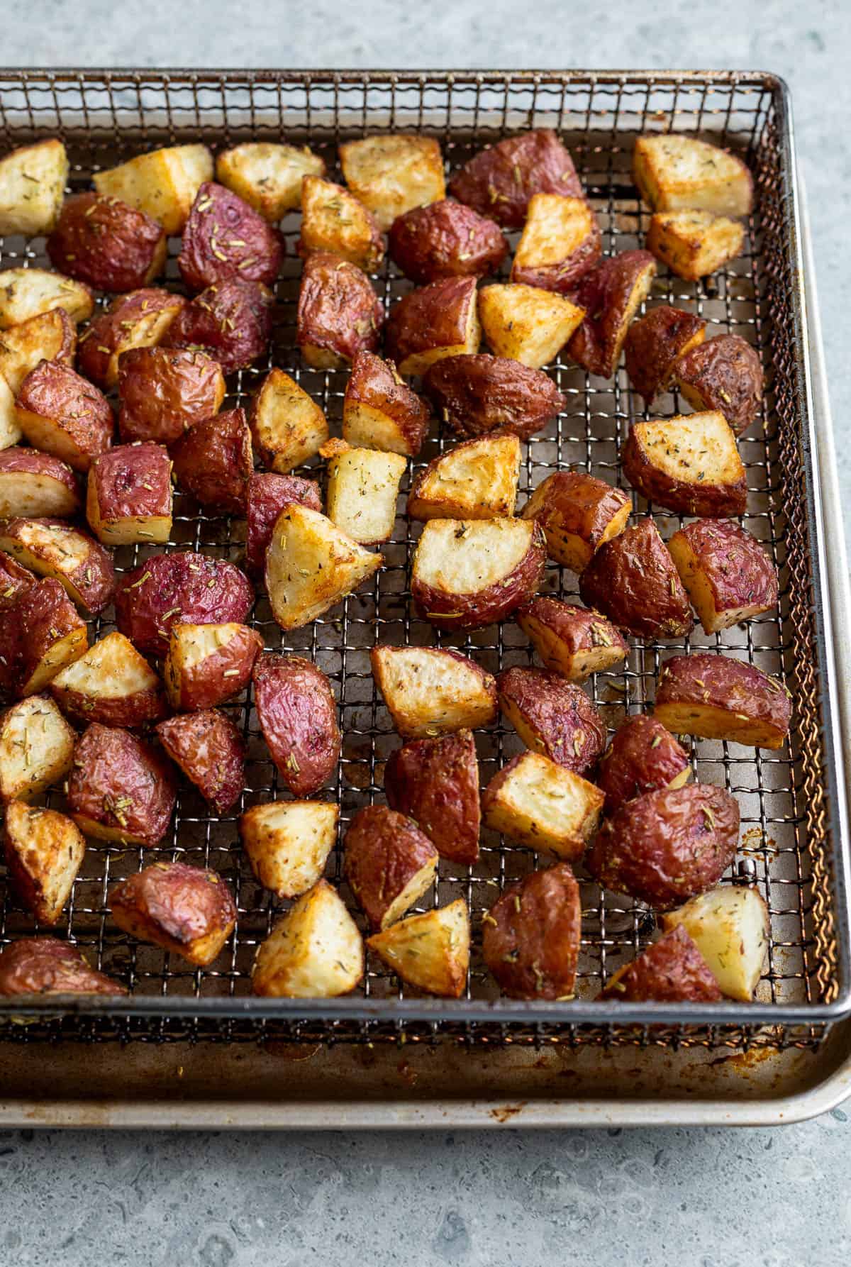 Roasted red potato chunks in the air fryer basket.