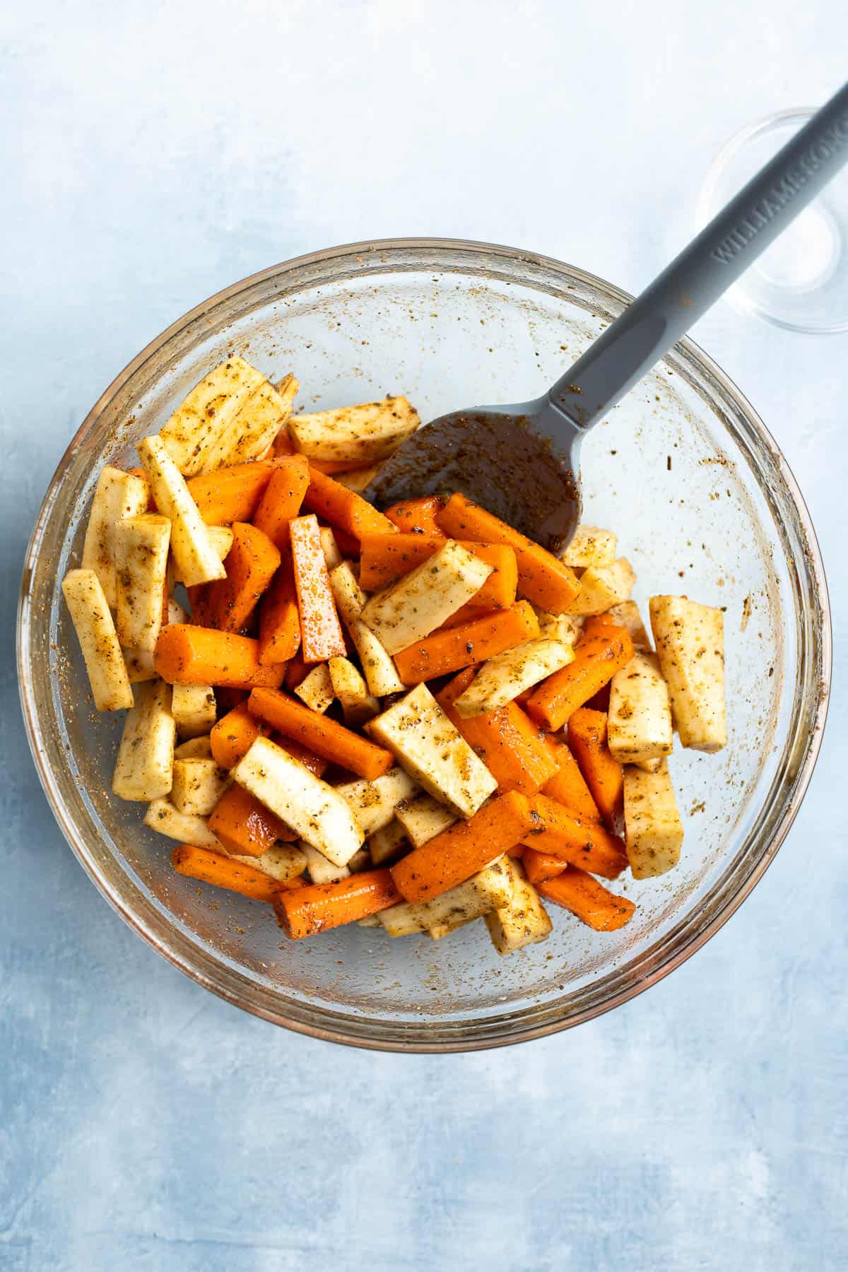 The carrots and parsnips tossed with oil, honey, and spices.