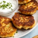 Crisp leftover mashed potato cakes on a plate.