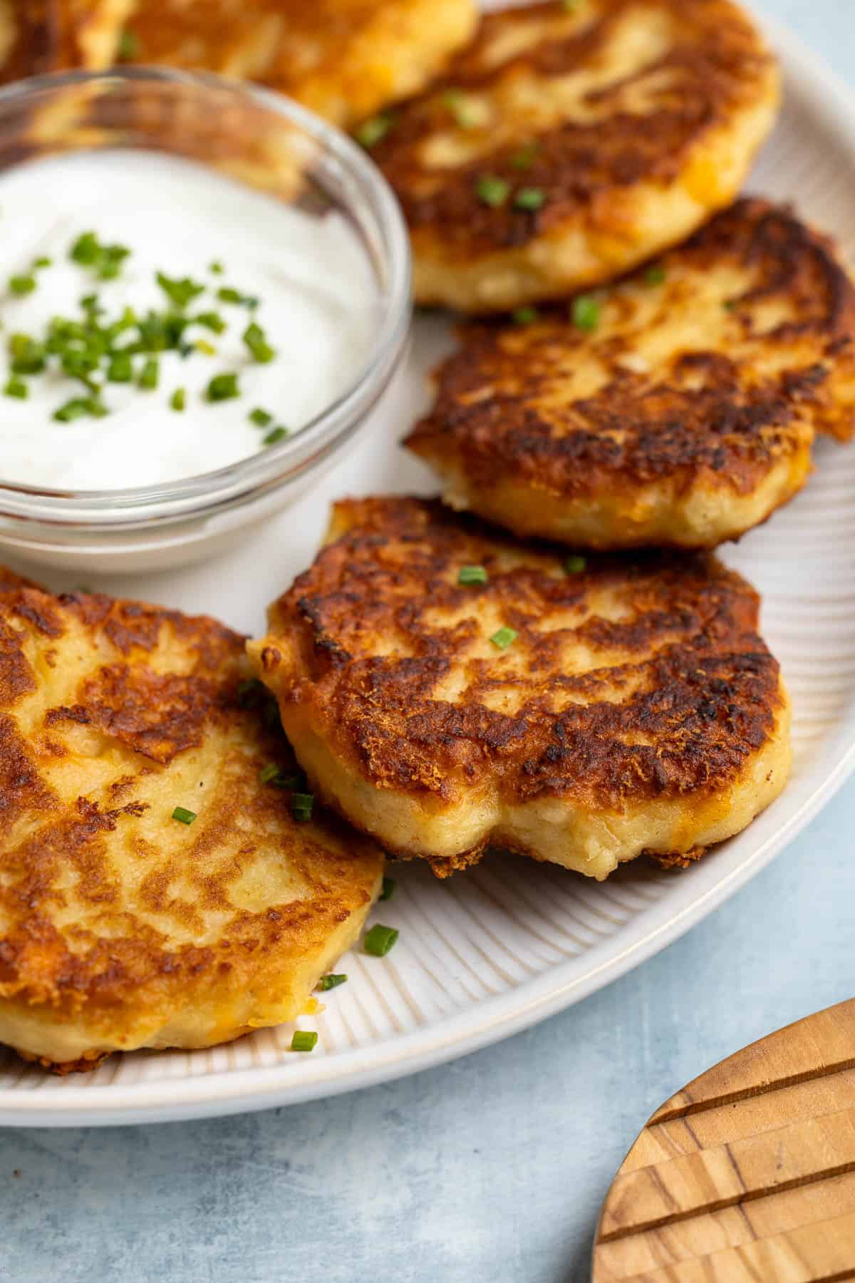 Crisp leftover mashed potato cakes on a plate.