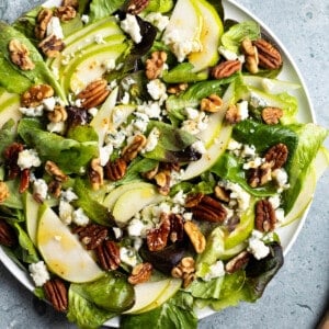 Pear slices, crumbled Gorgonzola, and toasted nuts on a mixed greens salad.
