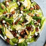 Pear slices, crumbled Gorgonzola, and toasted nuts on a mixed greens salad.