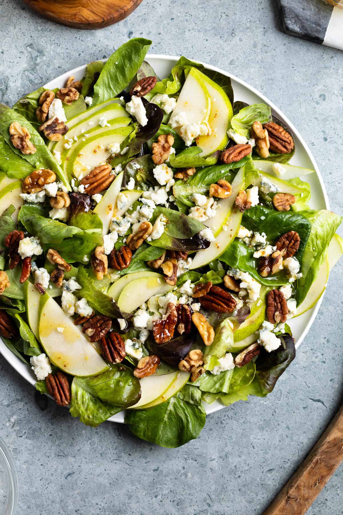 Pear slices, crumbled Gorgonzola, and toasted nuts on a mixed greens salad.