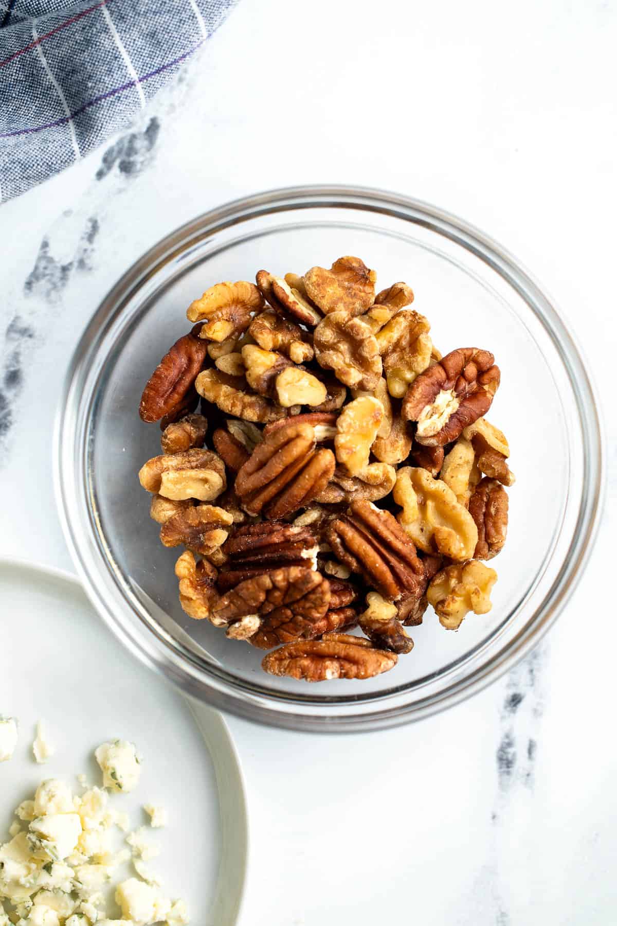 Toasted pecans and walnuts in a glass bowl.