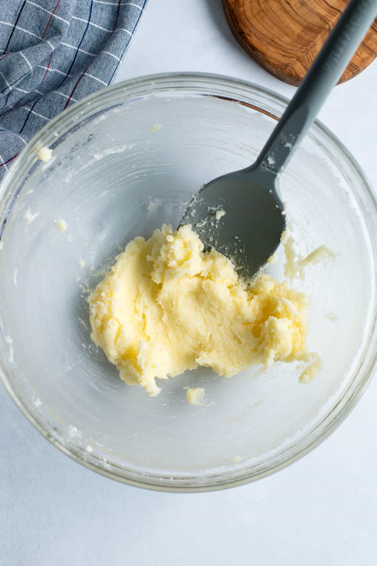 Butter and sugar creamed together in a mixing bowl.