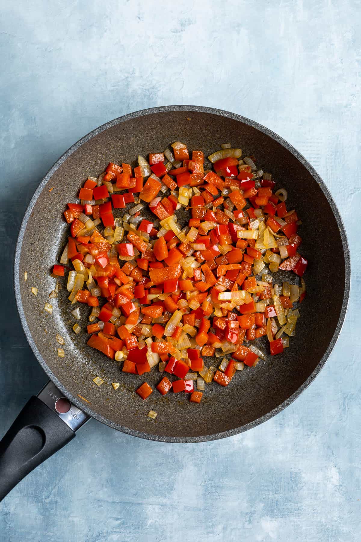 Sautéed onion and pepper in a skillet.