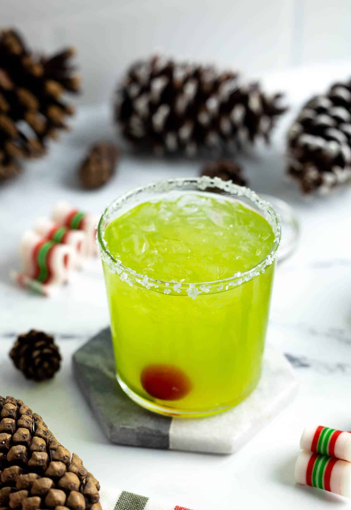 A grinch Christmas mule garnished with a maraschino cherry.