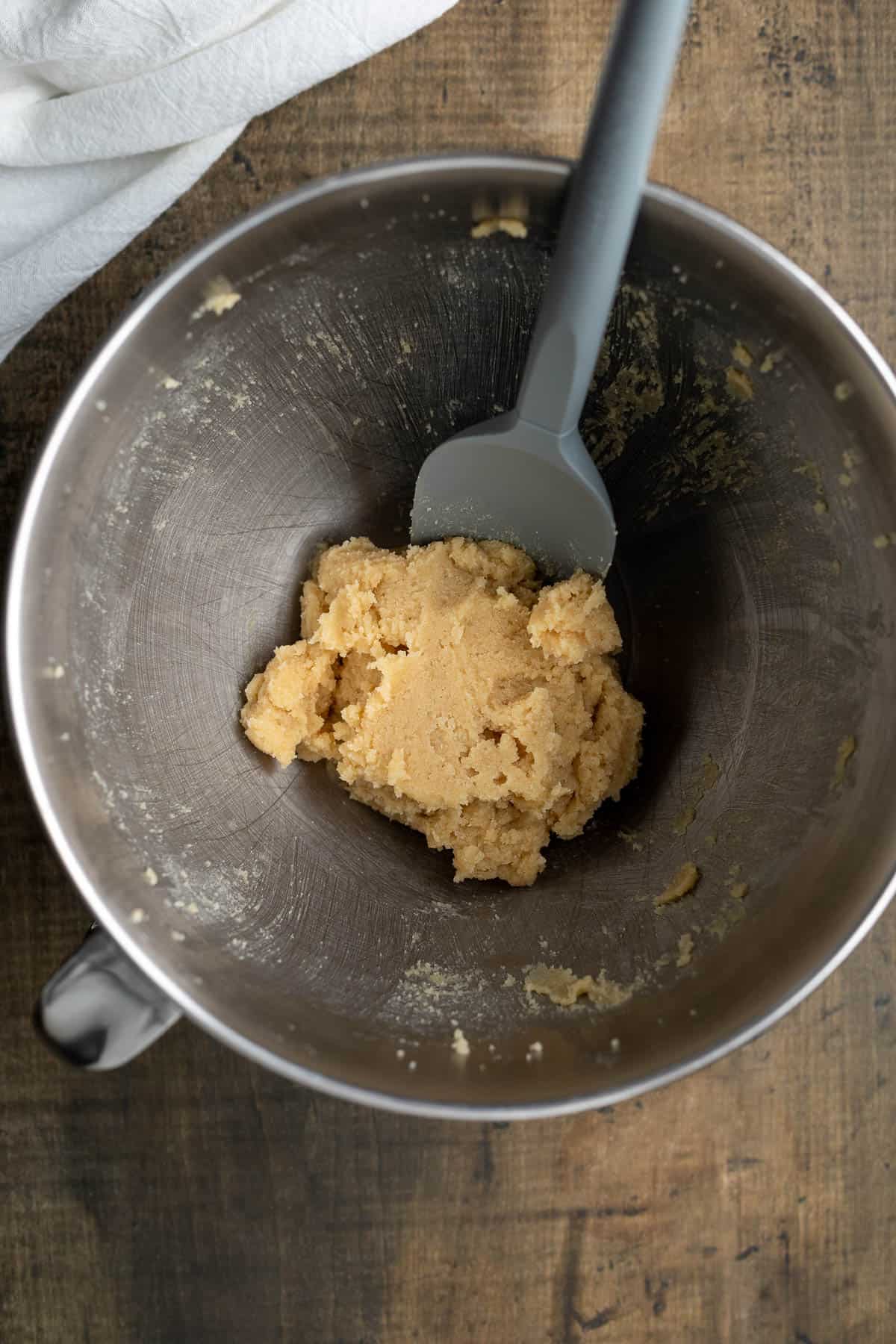 Creamed butter and sugars in a mixing bowl.