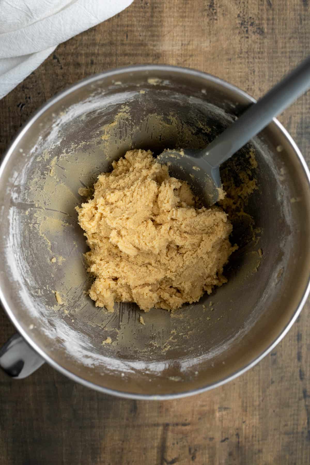 The cookie dough in a bowl before dying.