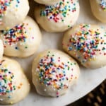 Italian anise cookies on a round marble serving board.