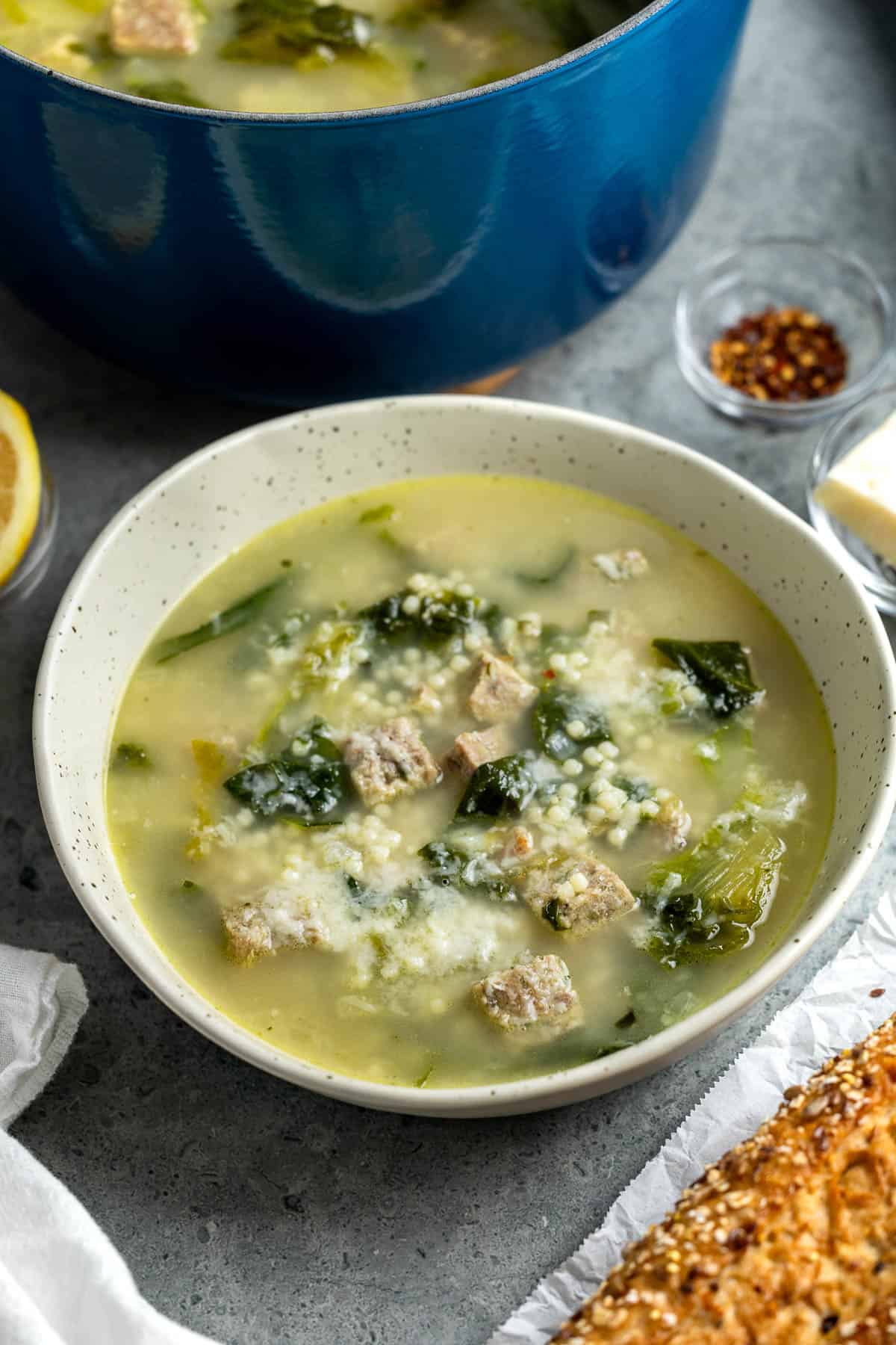 A bowl of Italian wedding soup with turkey meatballs.