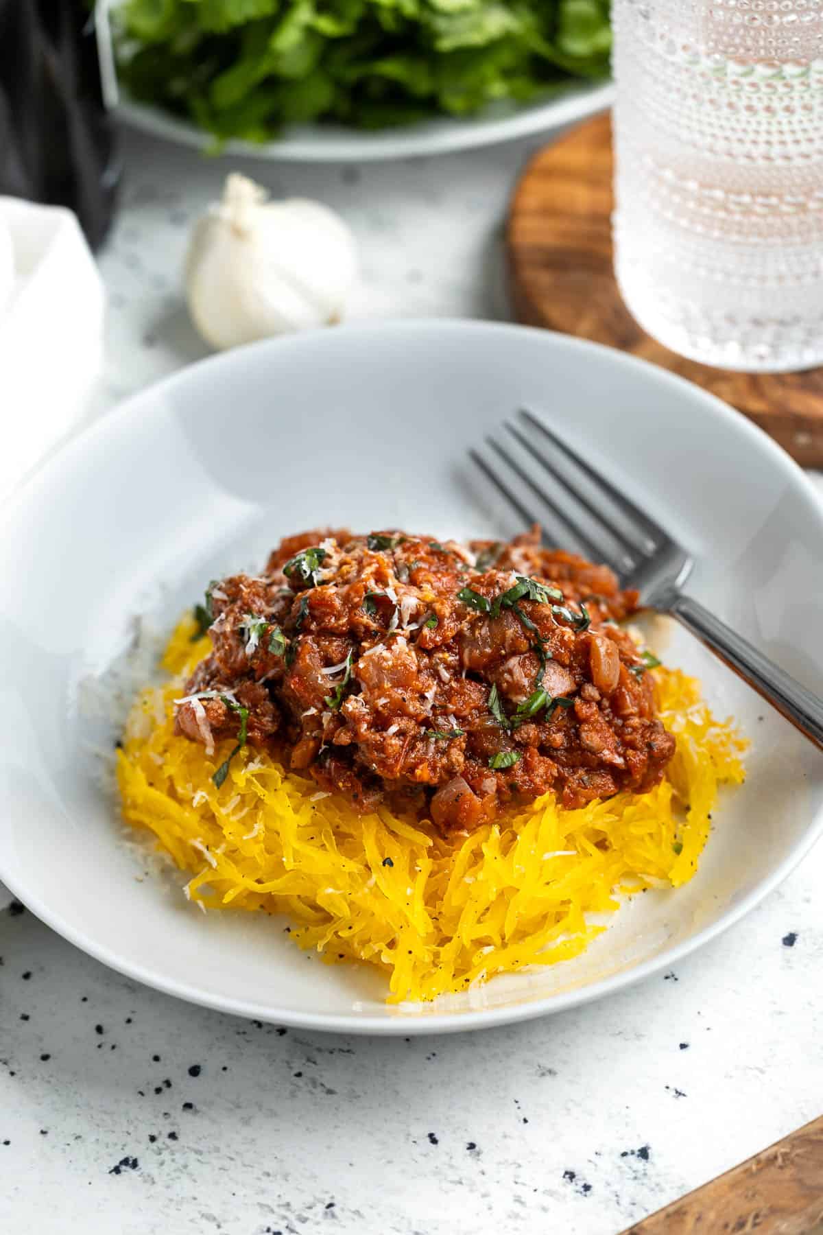 A serving of spaghetti squash bolognese in a shallow bowl.