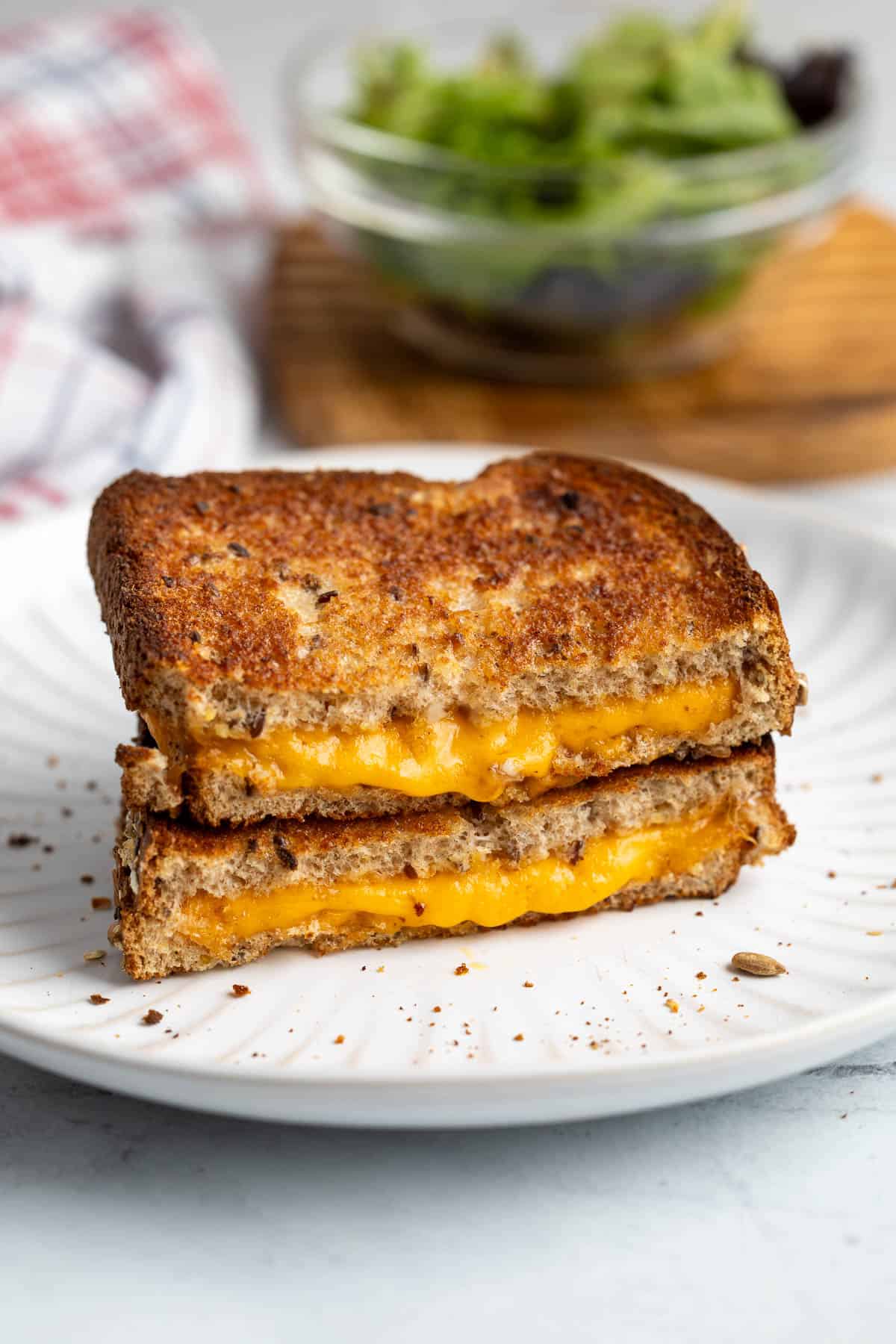 Two halves of an air fried grilled cheese stacked on top of one another.