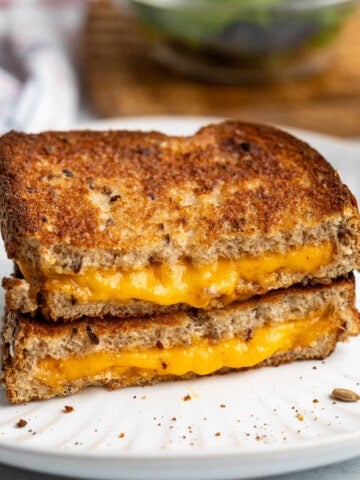 Two halves of an air fried grilled cheese stacked on top of one another.