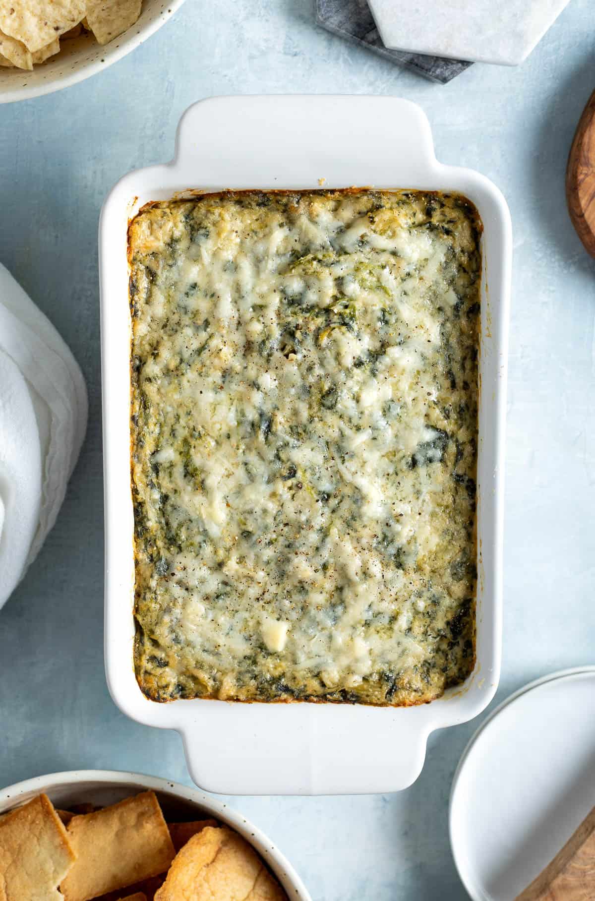 Baked no-mayo spinach artichoke dip in a dish.