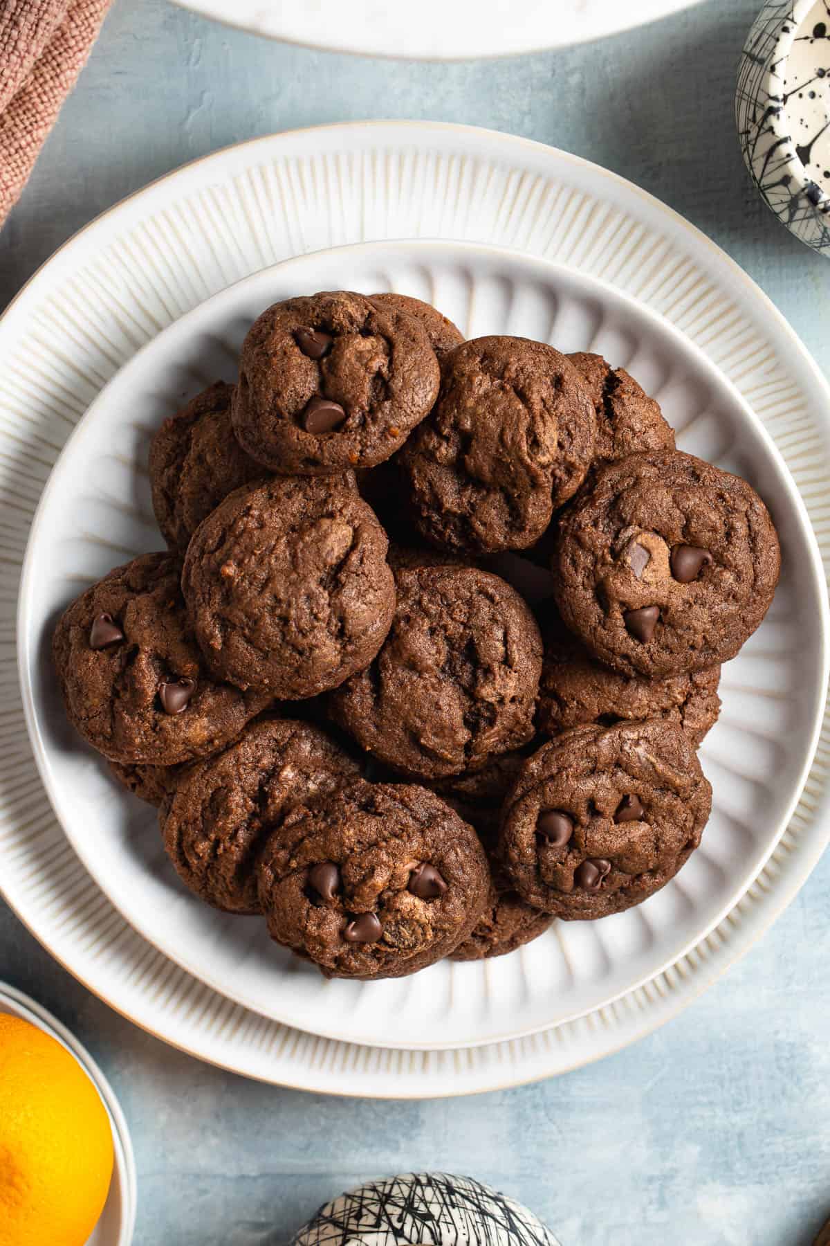 Chocolate orange cookies in a pile on a plate.