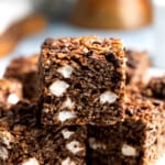 Chocolate marshmallow cereal treats arranged on a plate.