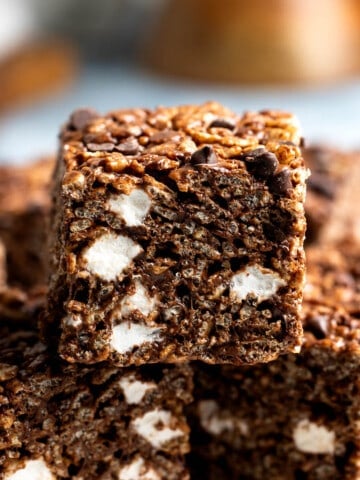 Chocolate marshmallow cereal treats arranged on a plate.