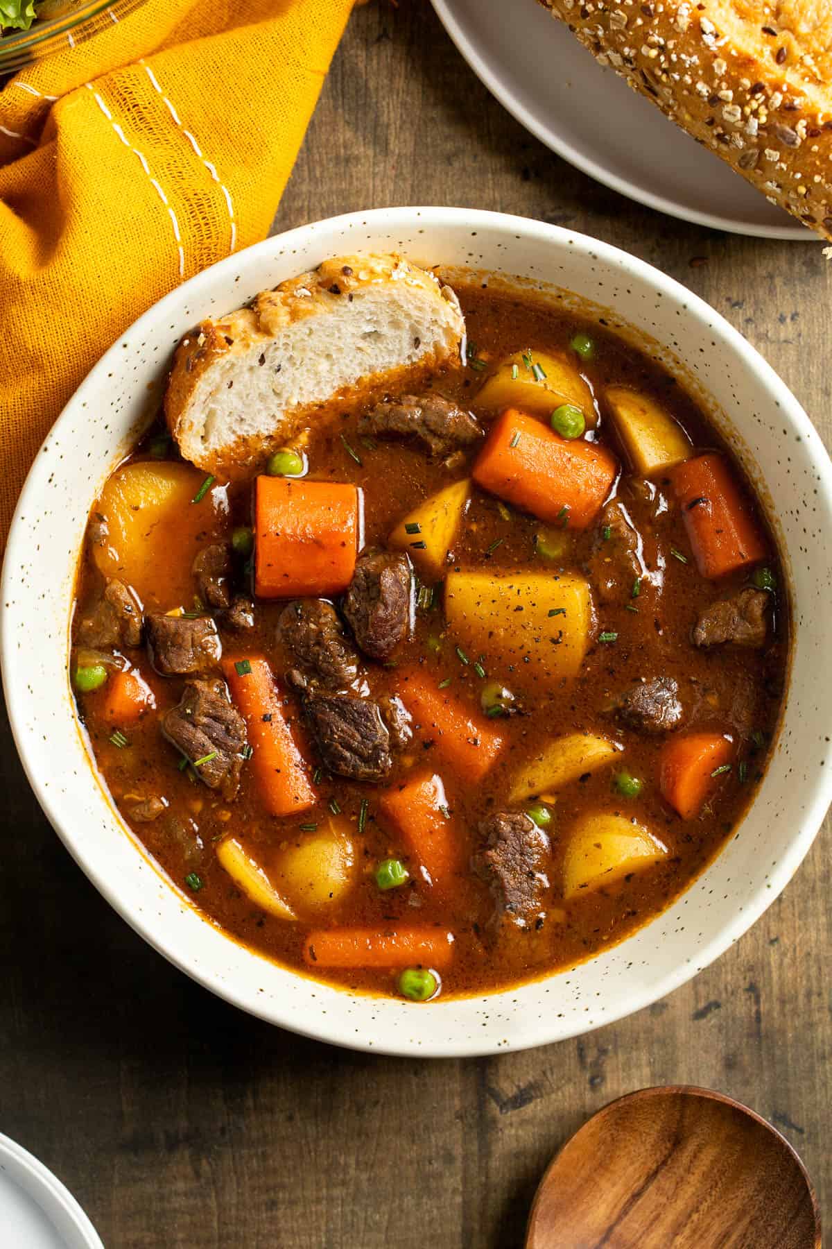 A serving of Guinness beef stew in a shallow ceramic bowl.