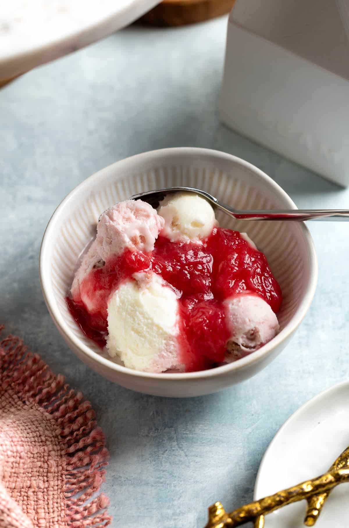 Chilled stewed rhubarb dolloped over vanilla and strawberry ice cream.