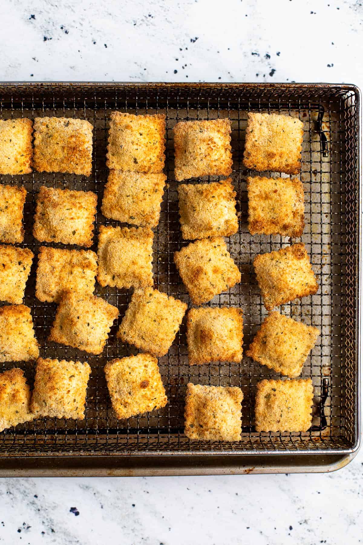 Air fryer toasted ravioli done on the wire basket.
