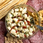 A bowl or marinated mozzarella in the middle of an antipasto platter.