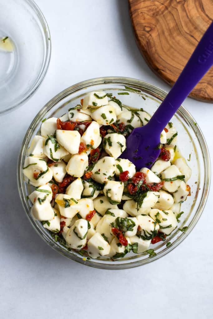 Mozzarella pearls stirred into the seasoned olive oil mixture.