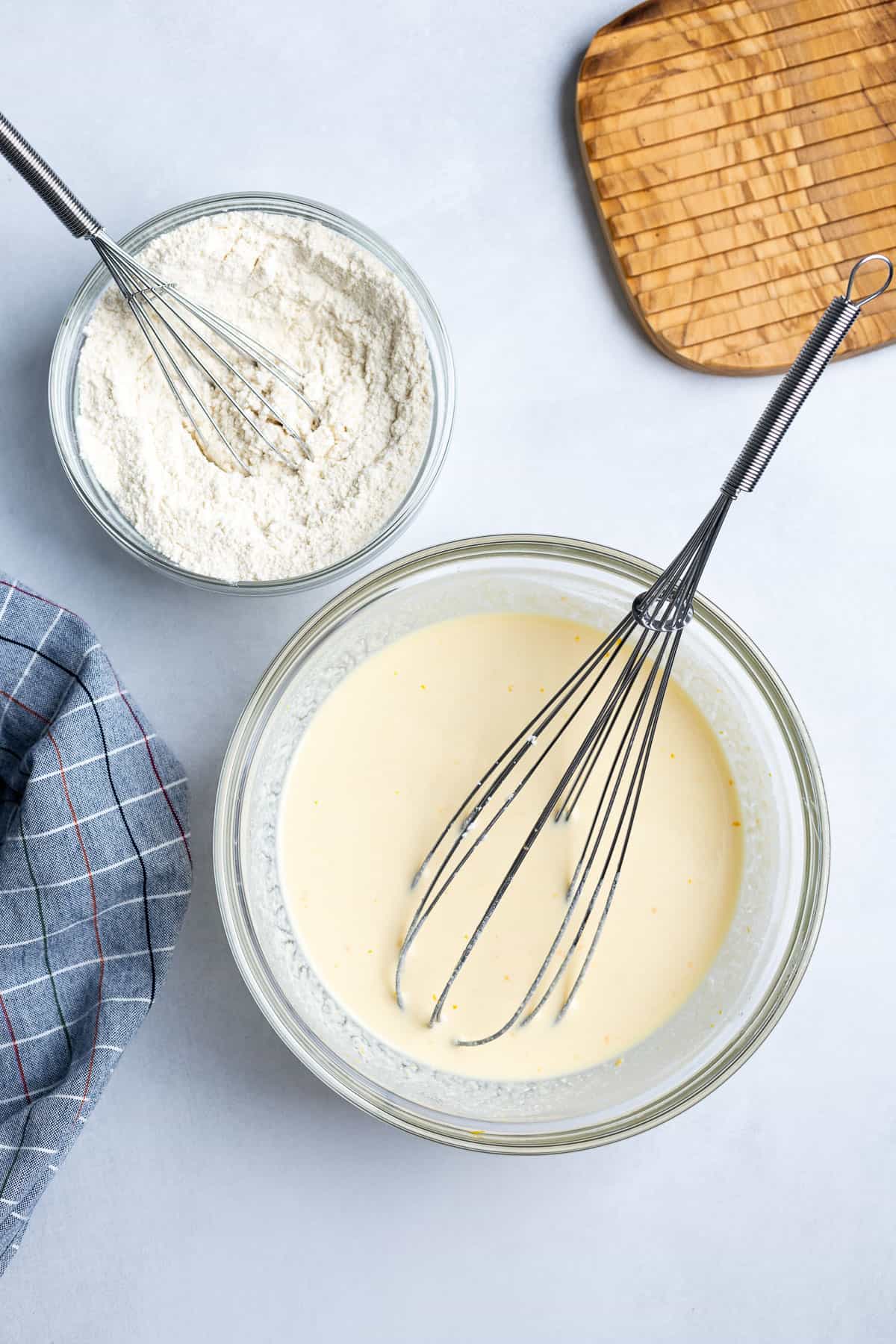 Wet and dry ingredients whisked together in separate bowls.