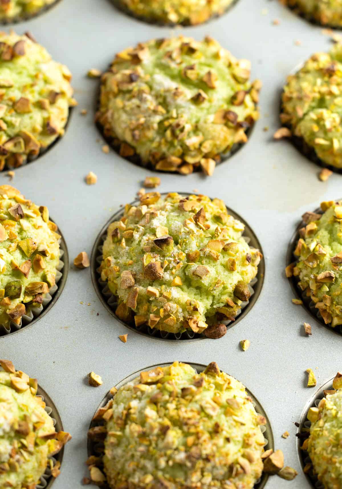 Baked pistachio muffins in the muffin tin.