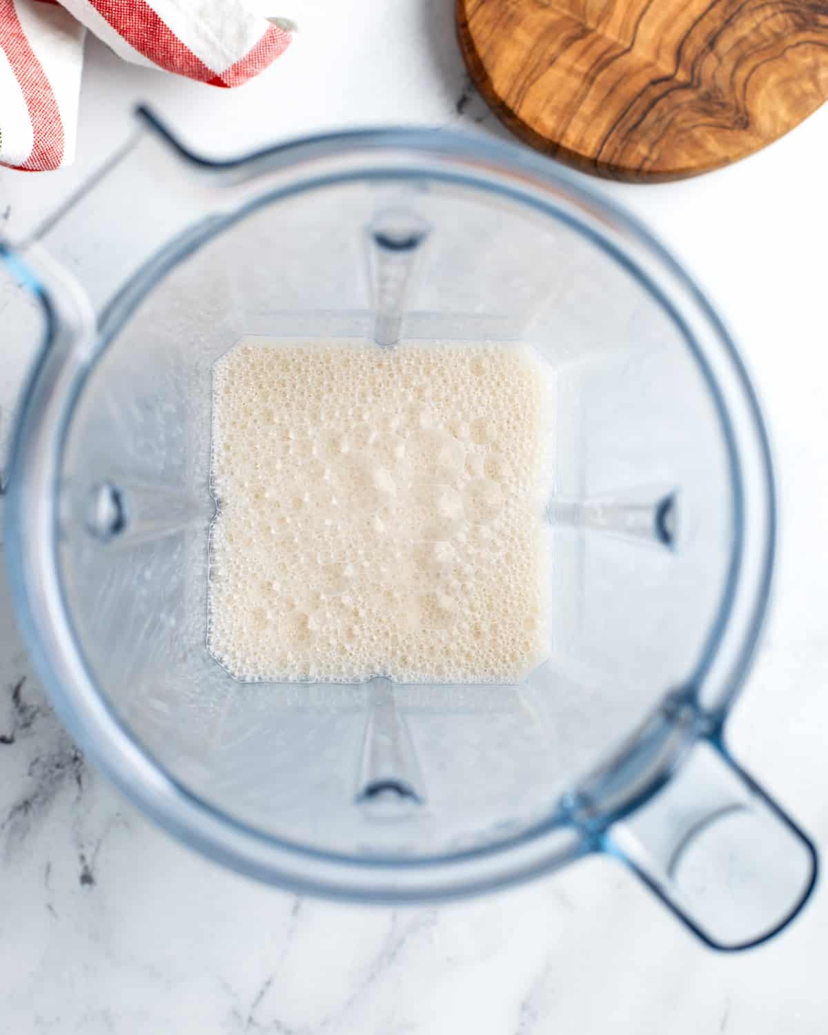 Foamed steamed milk in a blender with lots of bubbles.