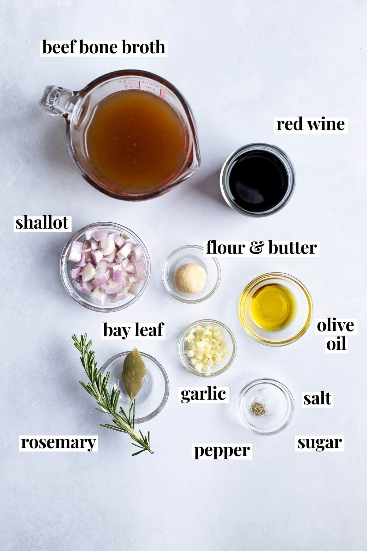 Labeled red wine jus ingredients in separate bowls and containers.