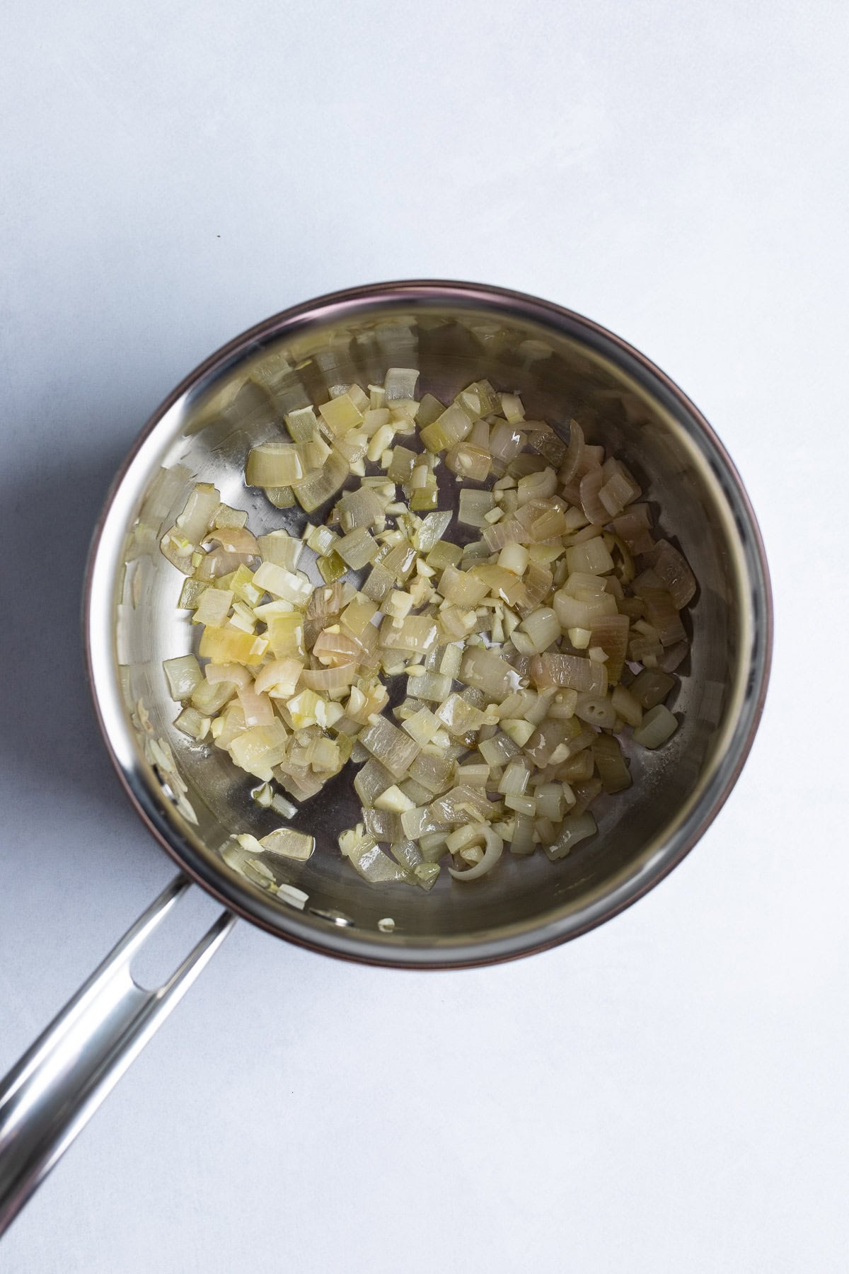 Sautéed shallot and garlic in a pan with olive oil.