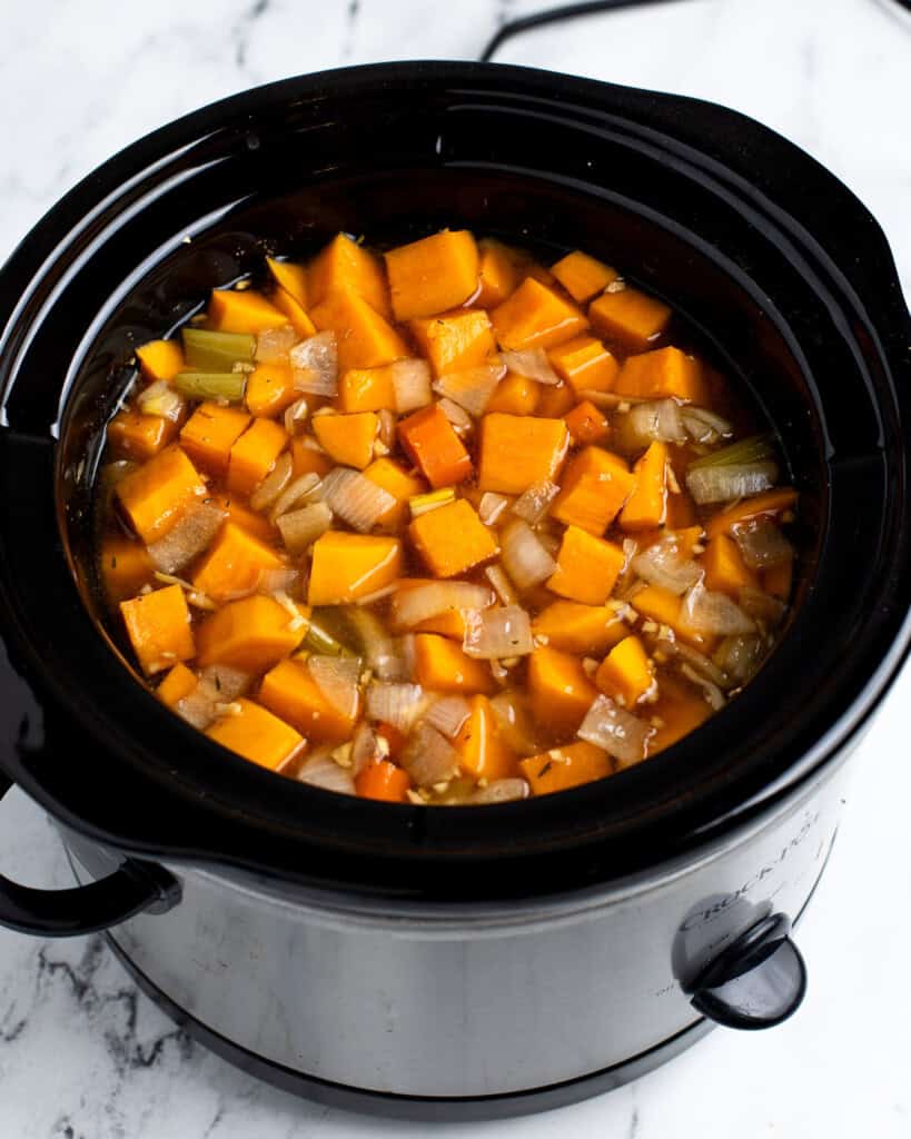 The cooked soup in the slow cooker before pureeing and adding coconut milk.
