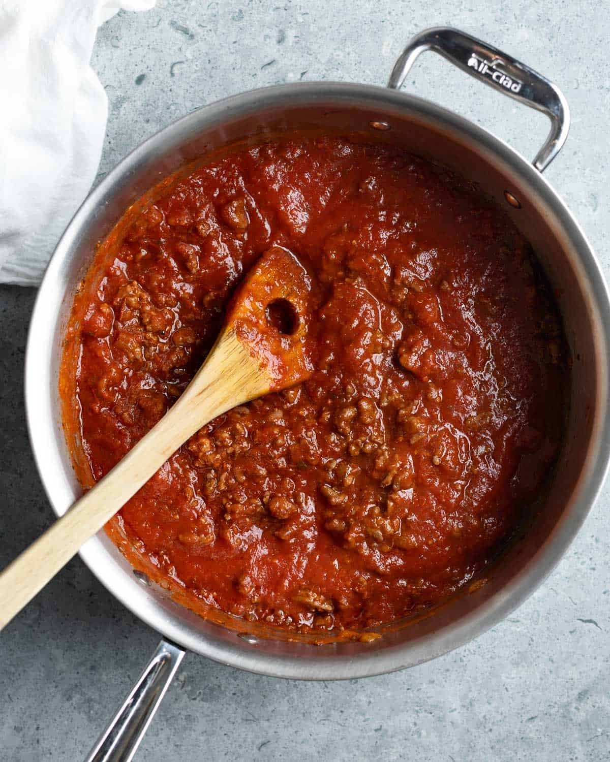Wine and crushed tomatoes simmering in the saucepan.