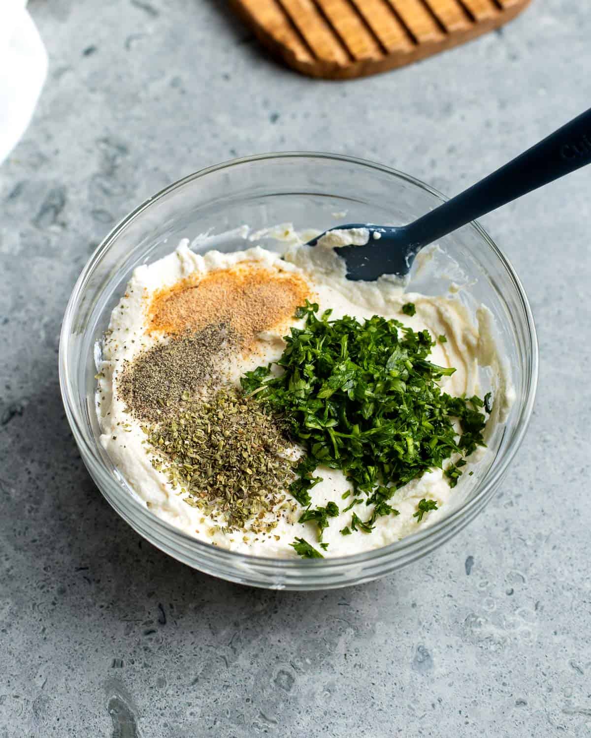 Ricotta cheese topped with herbs and seasonings.