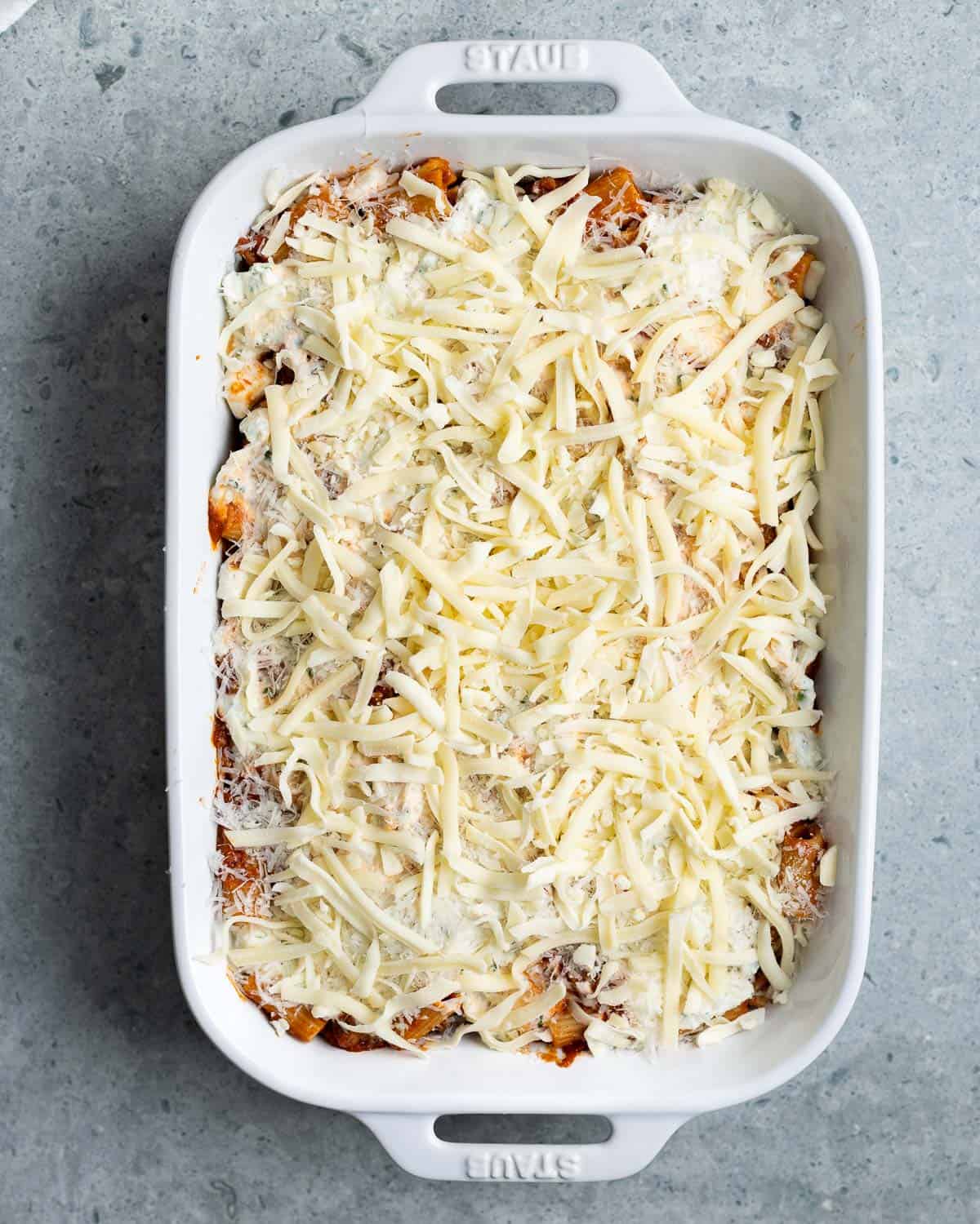 The pasta topped with ricotta and all shredded cheeses.