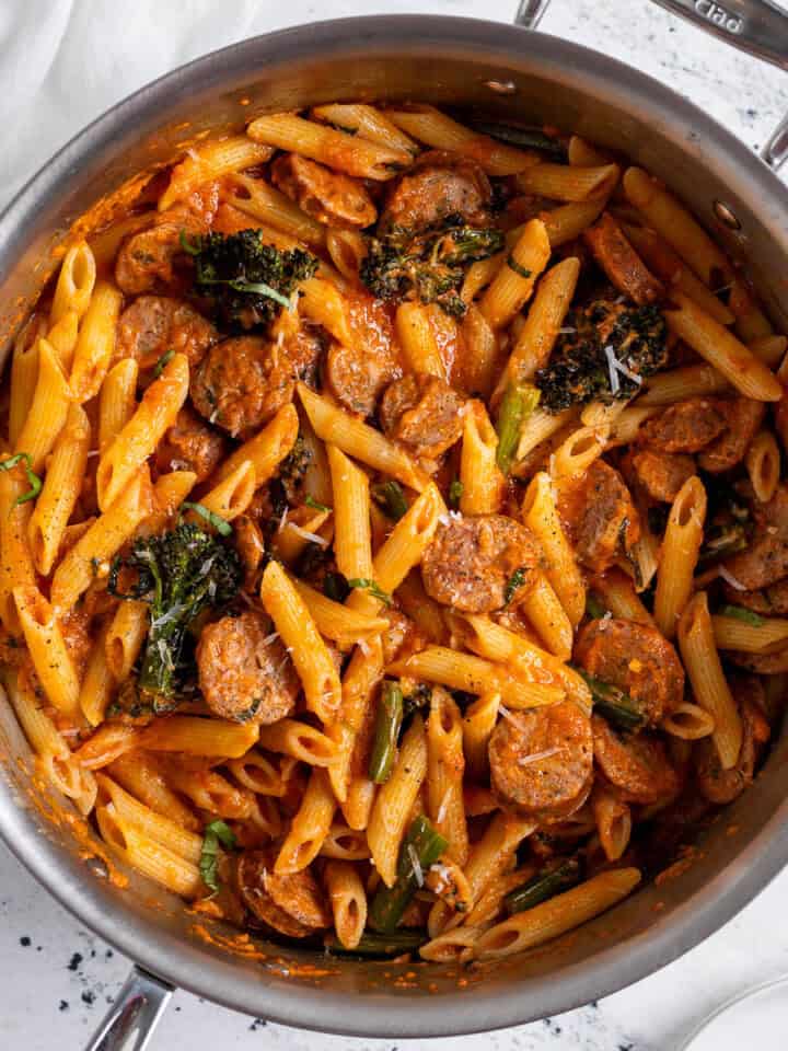 Chicken sausage pasta with broccolini in a large pan.