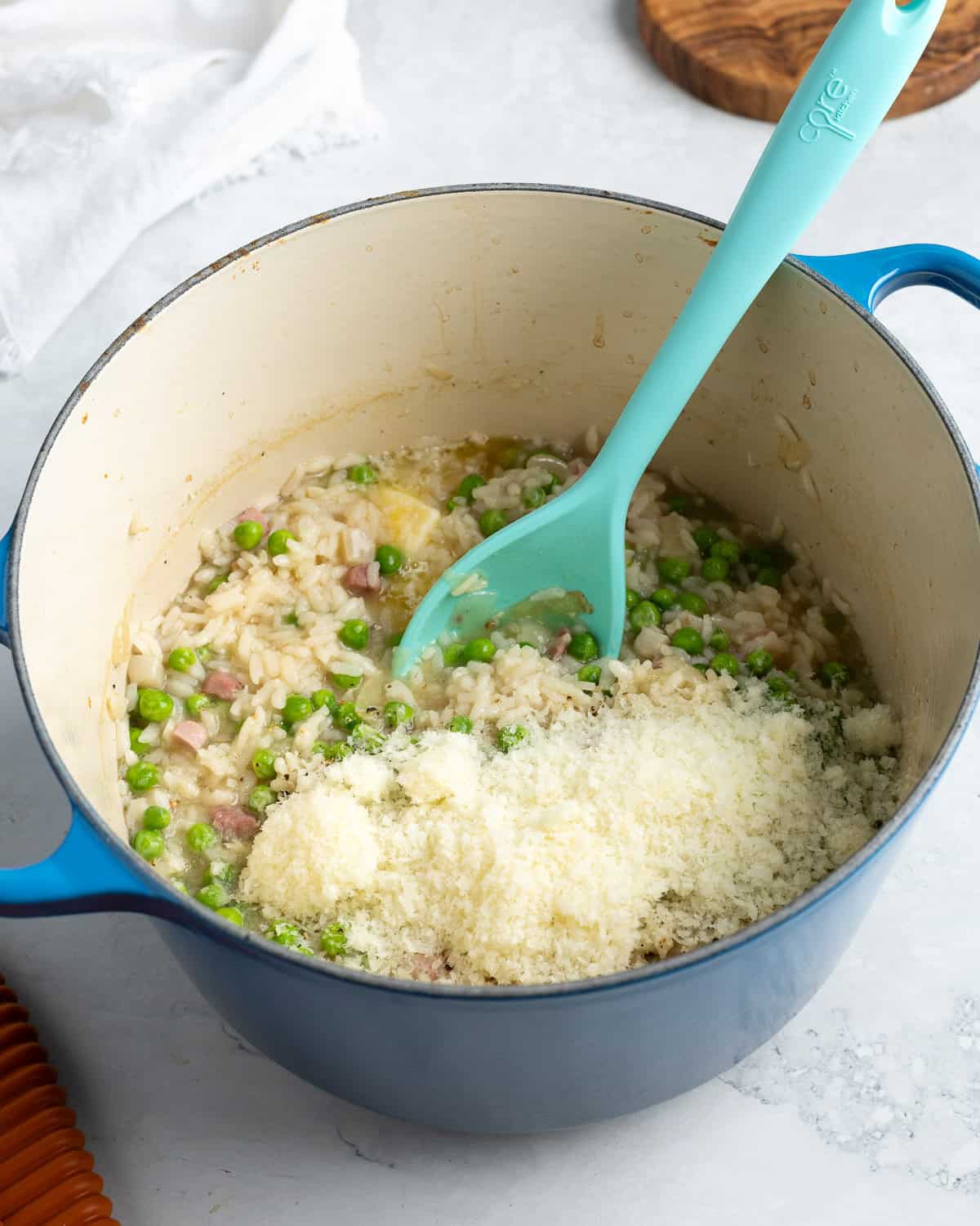 Shredded Pecorino, peas, and butter added to the cooked risotto.