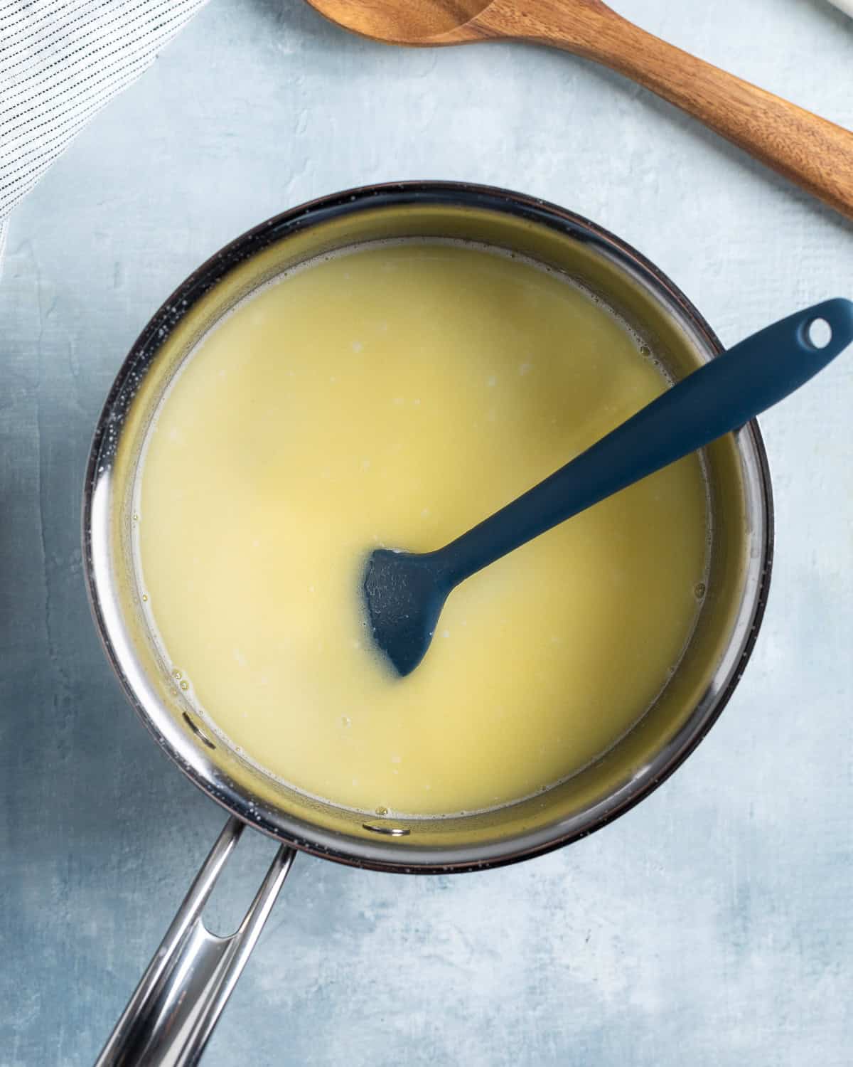Water, melted butter, and seasonings in a saucepan.