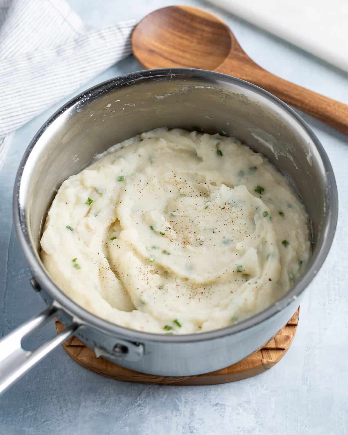 Thick swirls of mashed potatoes in a pan after the flakes have fully rehydrated.