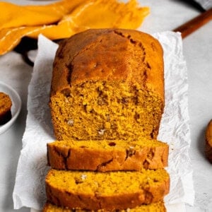 A partially-sliced loaf of Bisquick pumpkin bread viewed head-on.