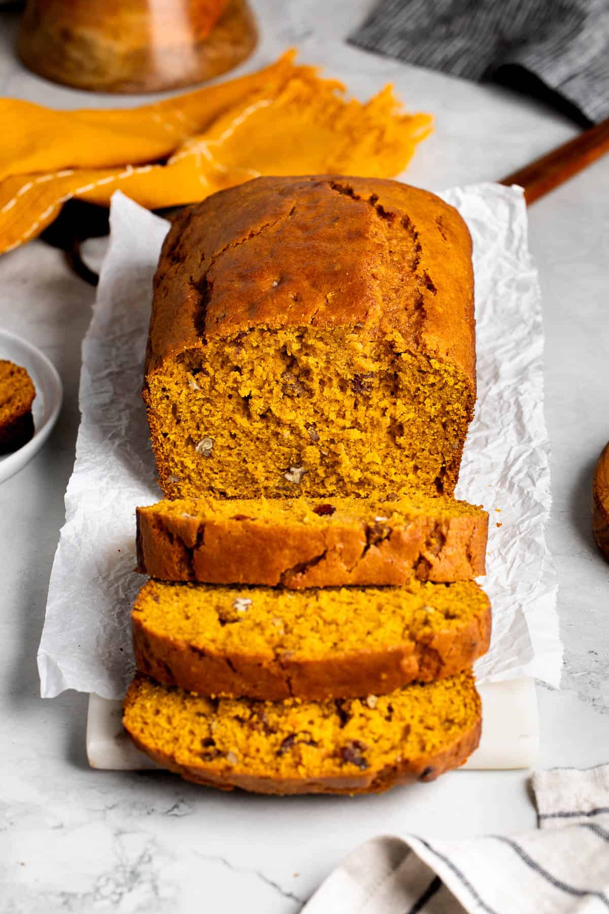 A partially-sliced loaf of Bisquick pumpkin bread viewed head-on.